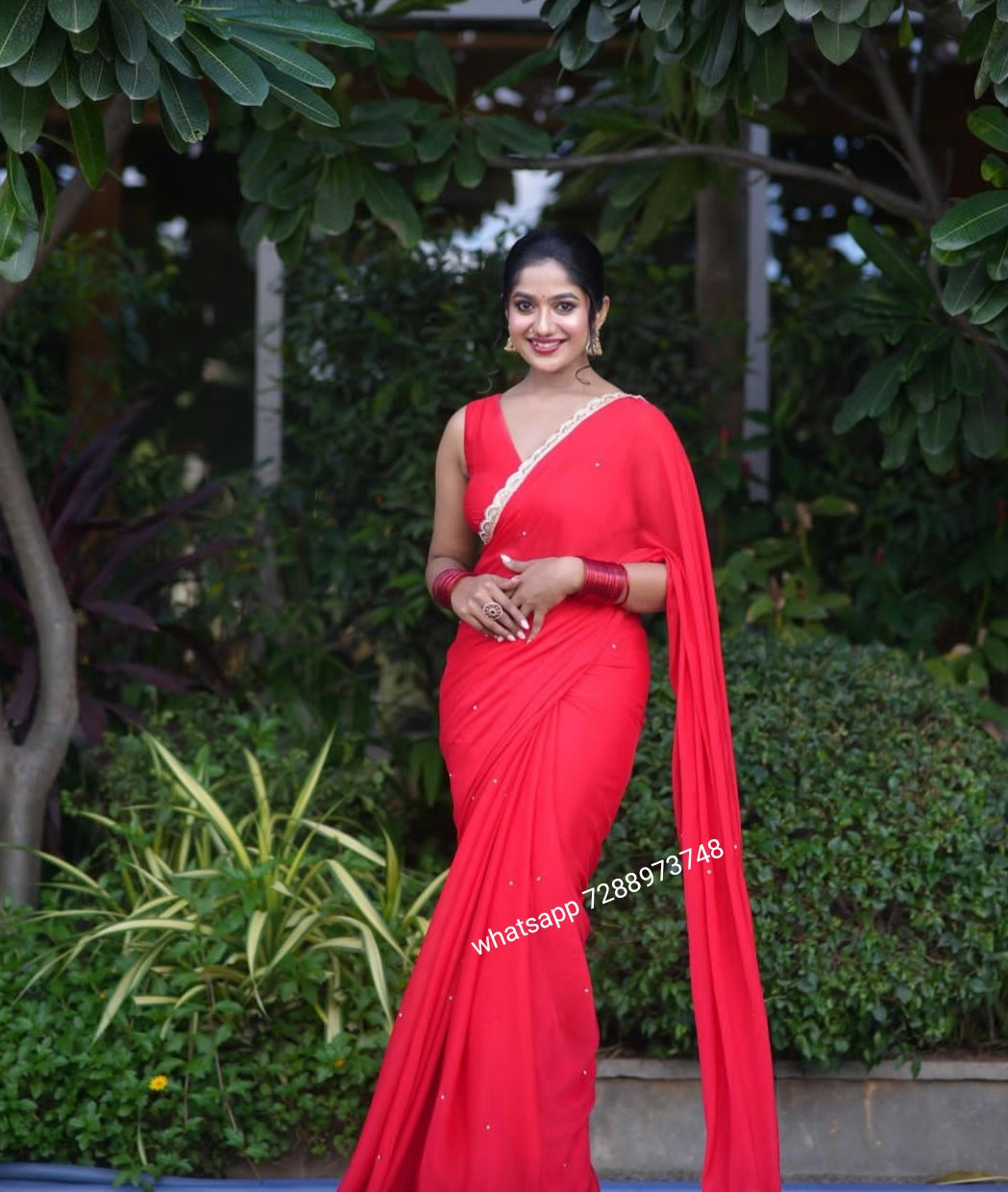 Red designer saree with lace and v-neck blouse