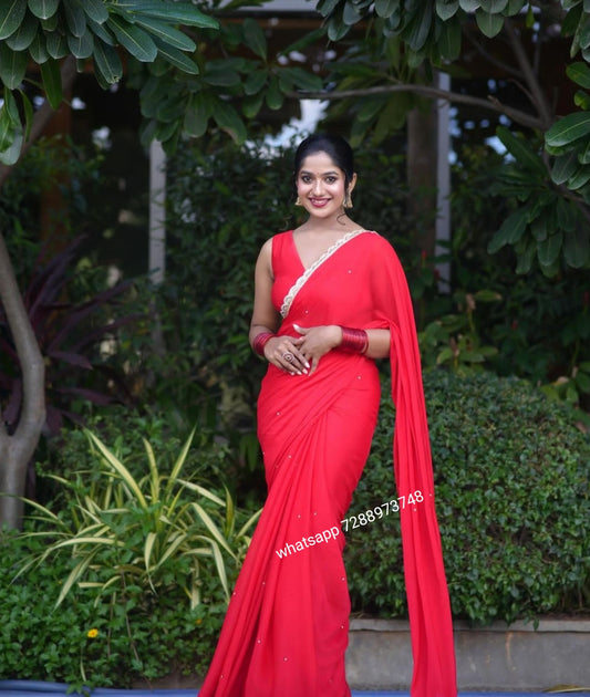 Red designer saree with lace and v-neck blouse
