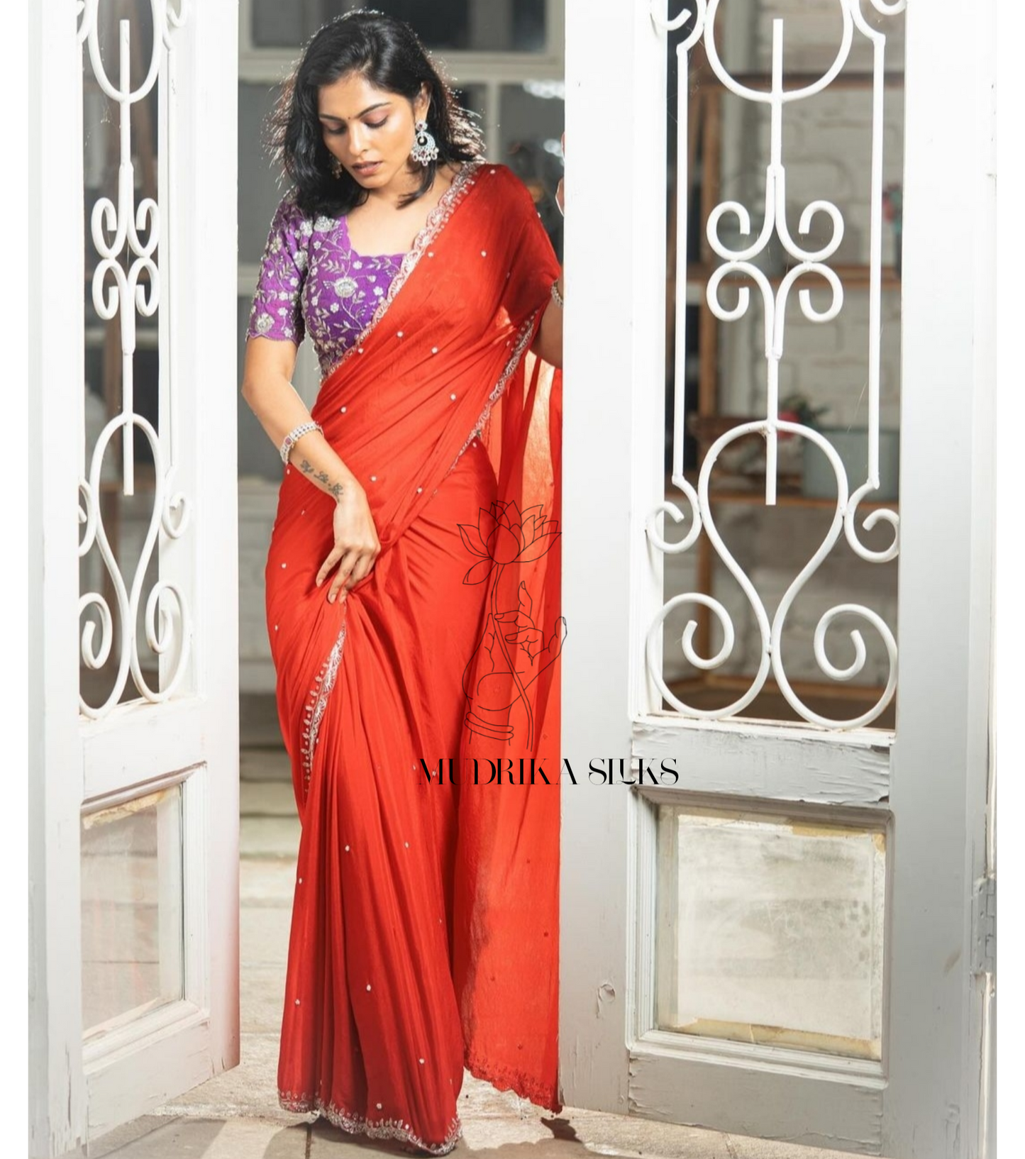Red designer saree with intricately worked scallop border