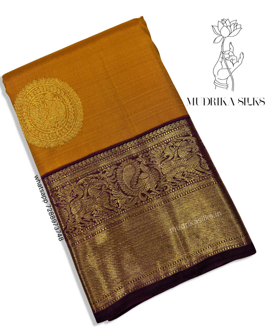 Mustard yellow Kanjivaram pattu sarees with jamun pink border